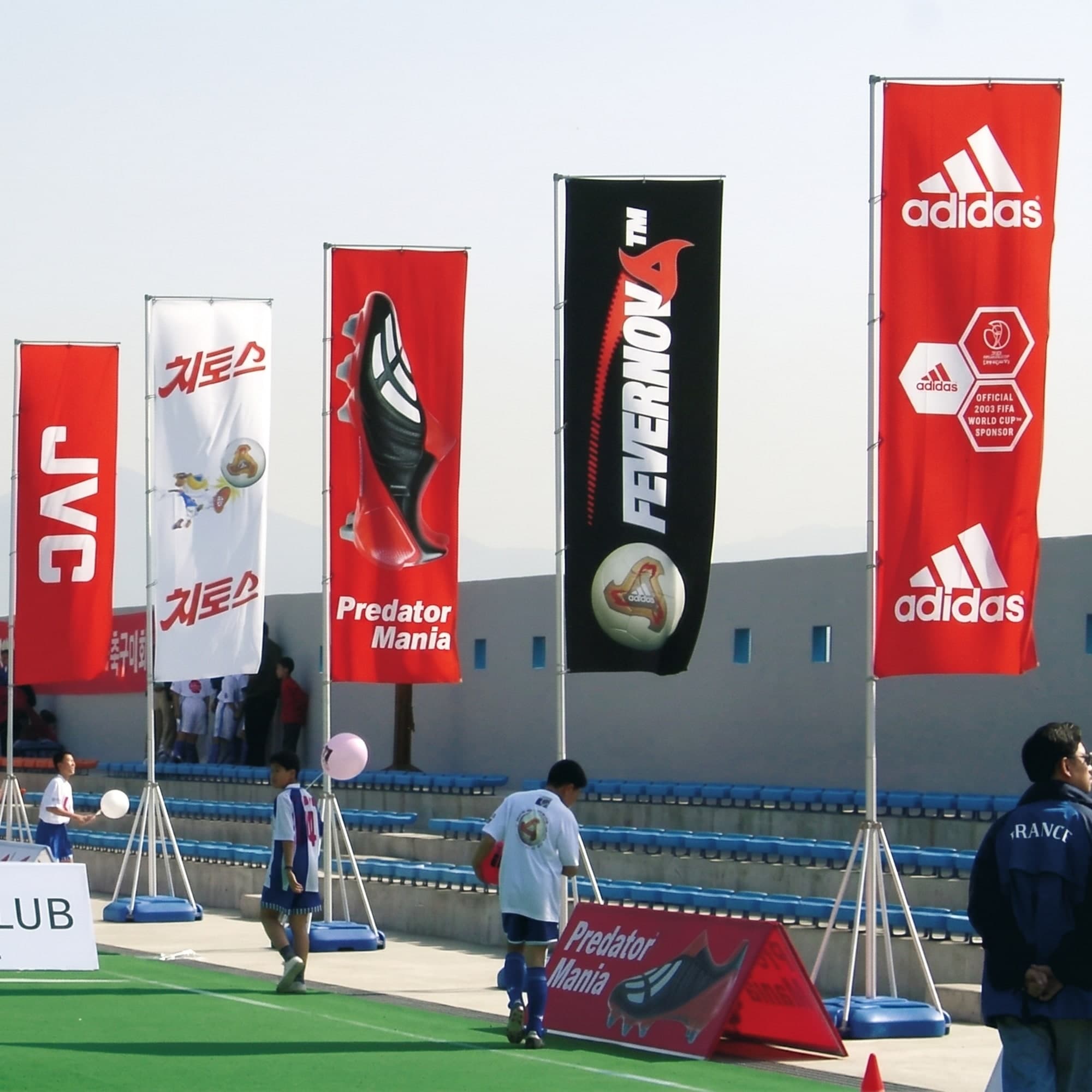 A row of promotional teardrop flags at an outdoor event