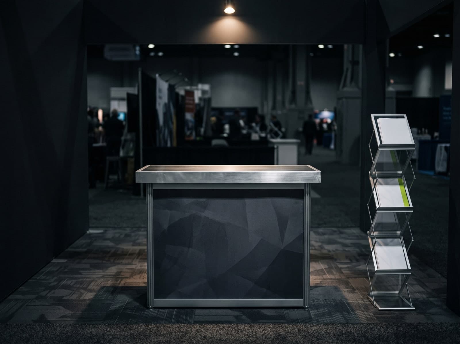 A branded portable counter and literature stand in a trade show booth
