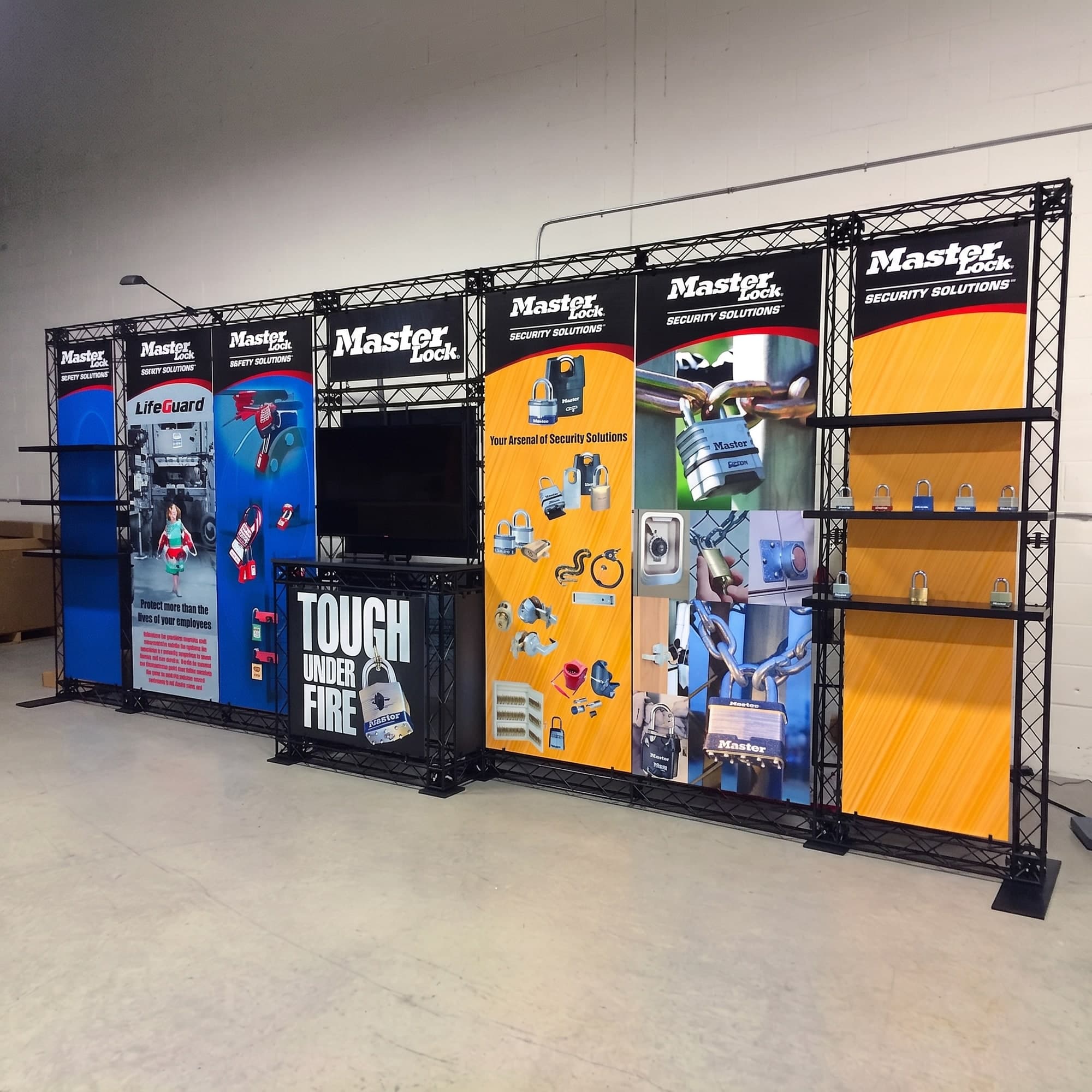 CrossWire truss exhibit with product shelving, monitor and counter built for Master Lock